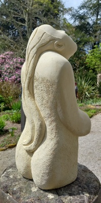 Back view of female figure in Maltese limestone with cascading hair tresses